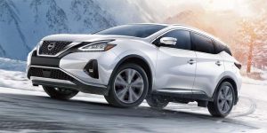 left angle front view of a white 2024 Nissan Murano driving through a snowy road | Vancouver, WA