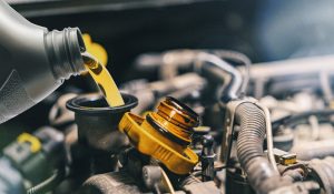 Pouring oil to car engine. Fresh oil poured during an oil change to a car | Vancouver, WA