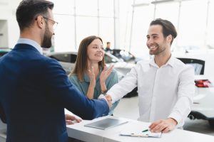 customer shaking hands with car salesman, confirming car financing and purchase | Vancouver, WA