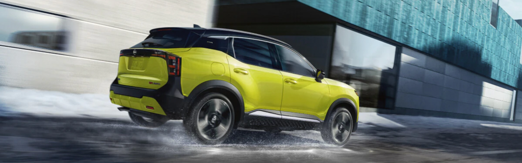 Bright yellow SUV driving on a snowy city street