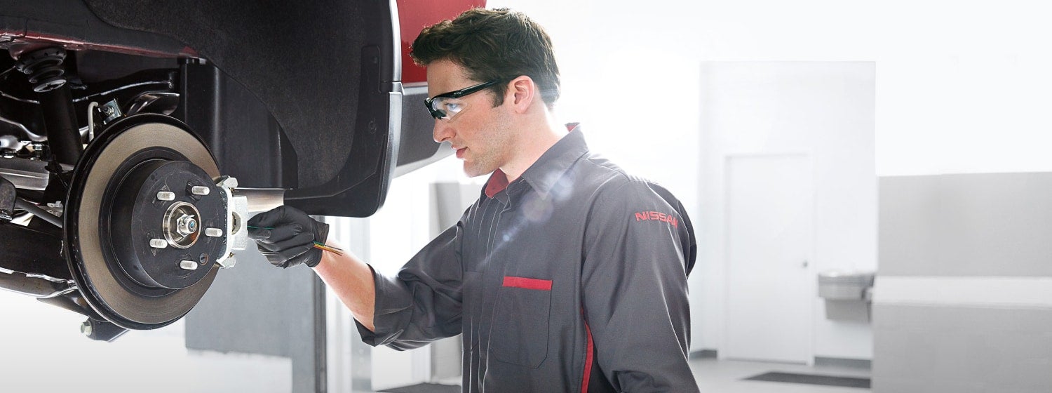 Automobile technician working on brakes
