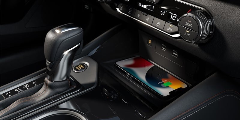 close up of the center console showcasing transmission stick and wireless charger for smart phone