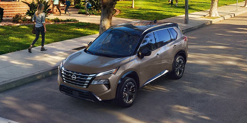 a 2024 nissan rogue parked outside of a home