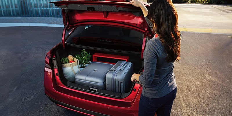 woman packing the spacious cargo space on the 2024 nissan versa